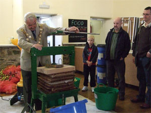 Mayor Vic May operating the fruit press