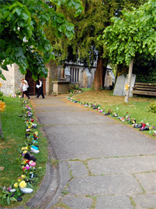 Flower filled shoes lining the path to the church