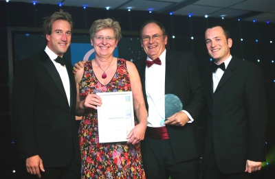 Tricia and Peter Howard accepting their Cornwall Tourism Award from Ben Fogle