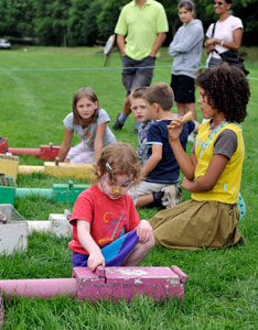 Children looking at ferrets